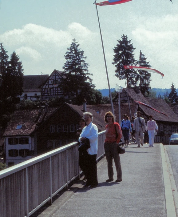 many people walking on the bridge over the water