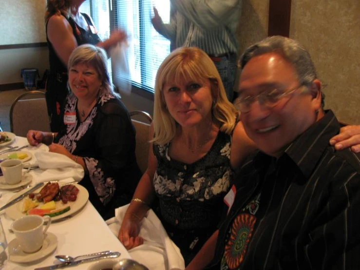 four people sitting around a table having an elaborate meal