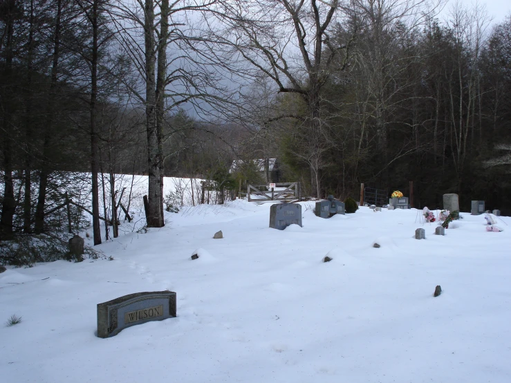 a cemetery with snow around it during the winter