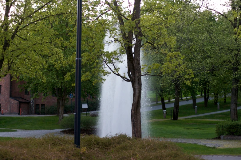 an elegant water feature sits in the middle of a field