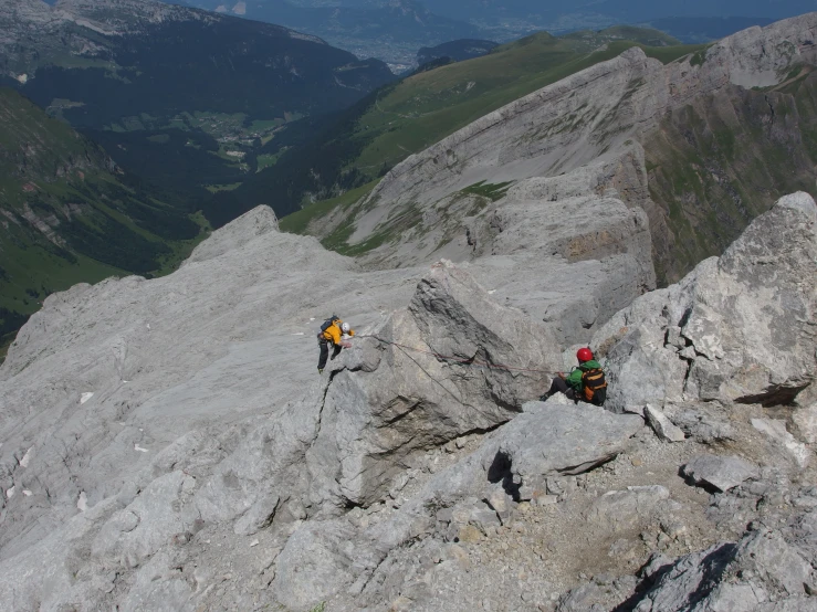 there is an image of mountain climbers climbing the peak