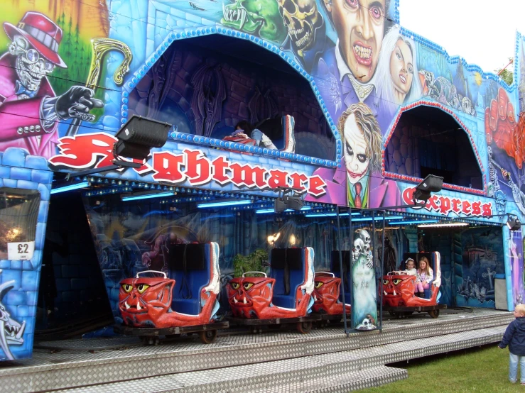 a carnival on the side of a train track