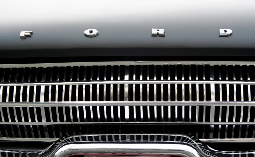 a black ford grille with ford's logo in the center