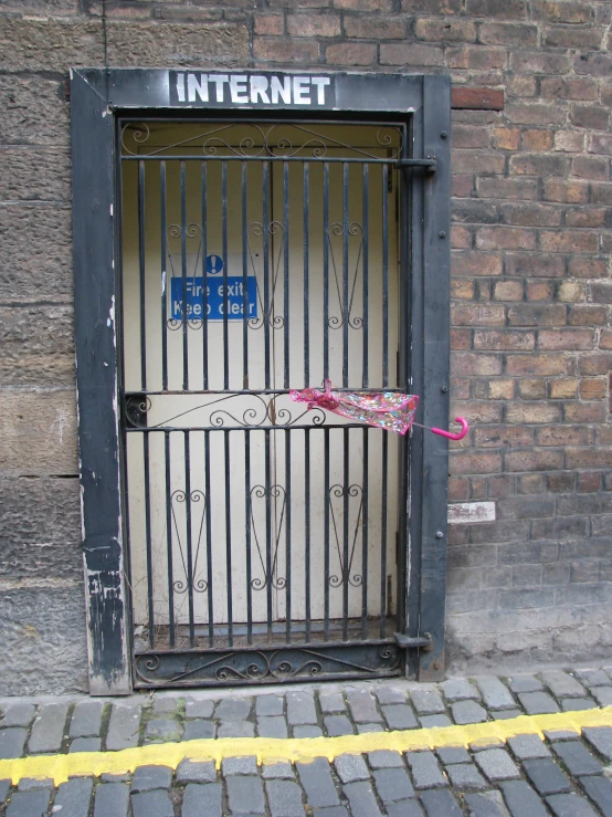 a red umbrella sitting in a  cell door