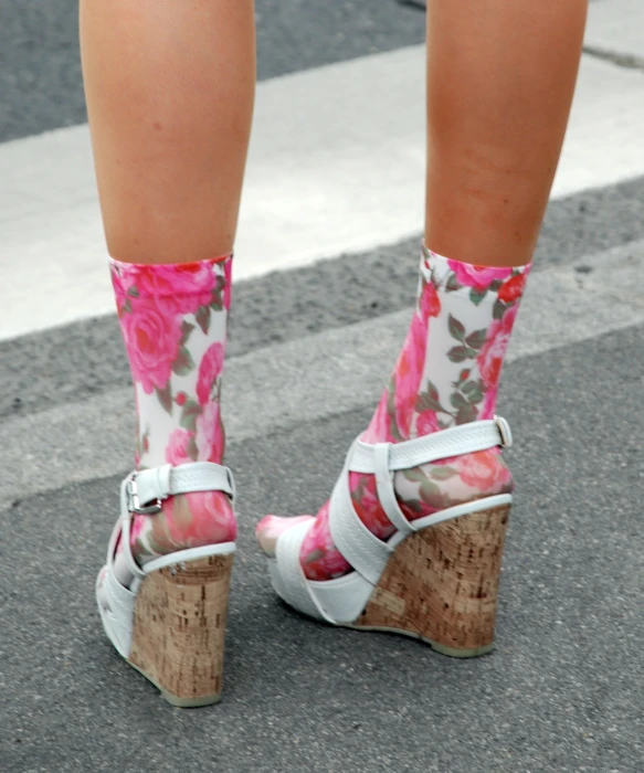 a close up view of someone's pink floral shoes