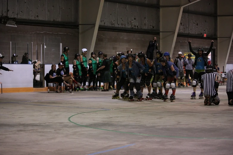 a crowd of people watching a group of roller blades