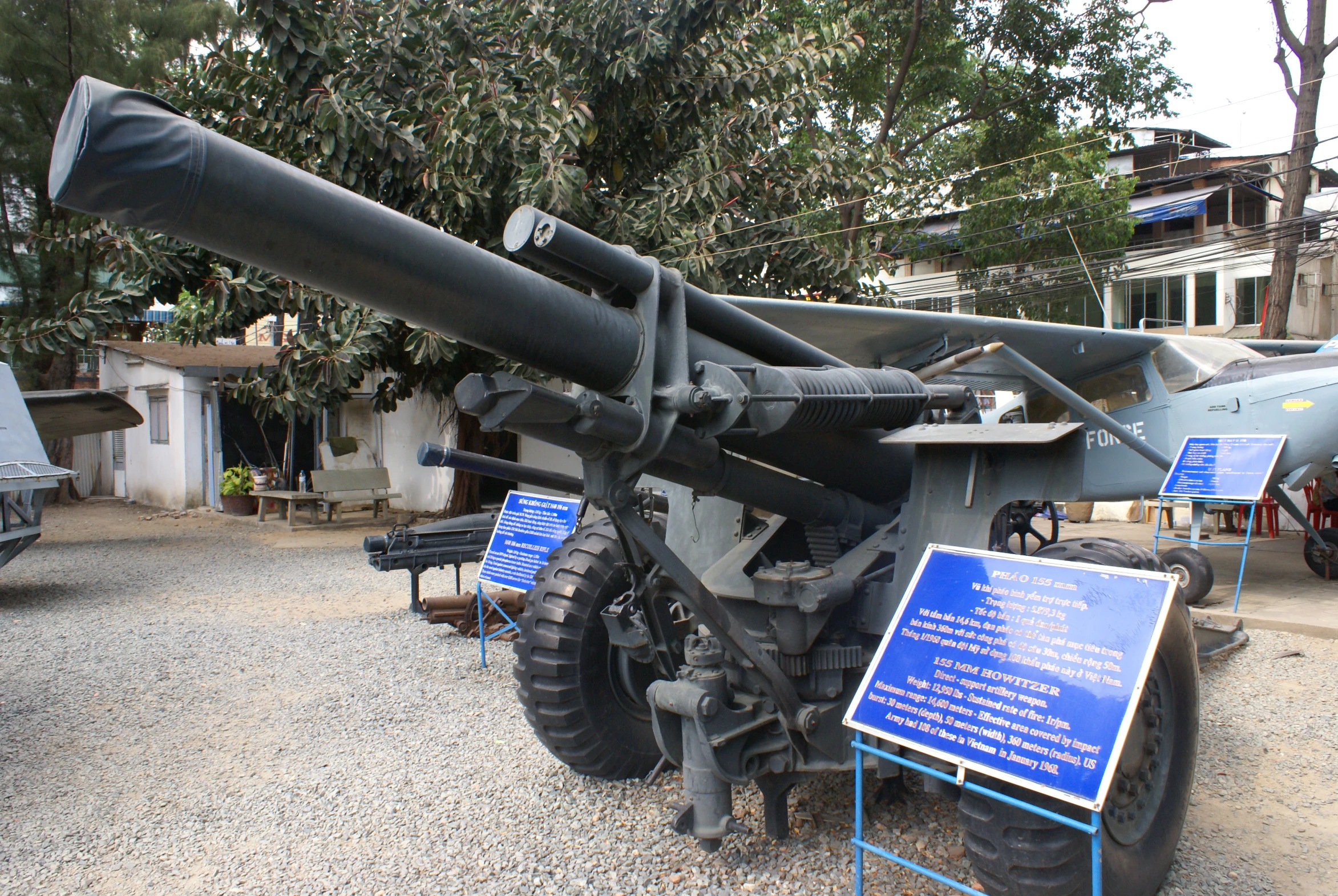 a big military gun with an iron structure that has many signs on it