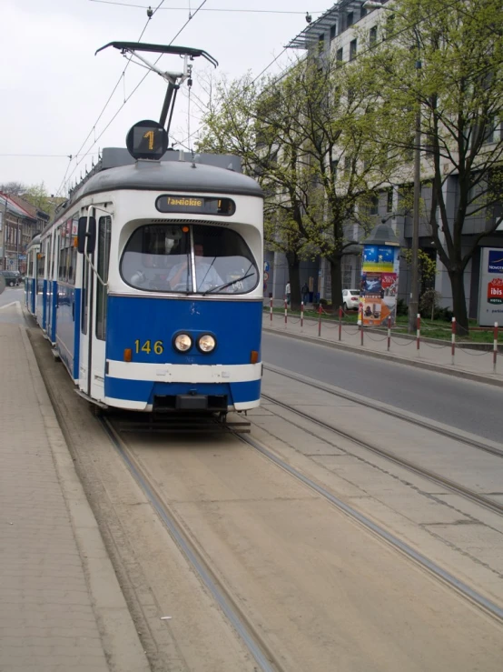 a trolley passing through a residential area on the tracks