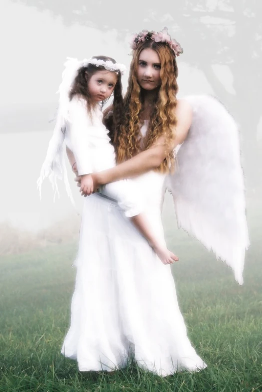 a po of two angels in white dresses standing close together