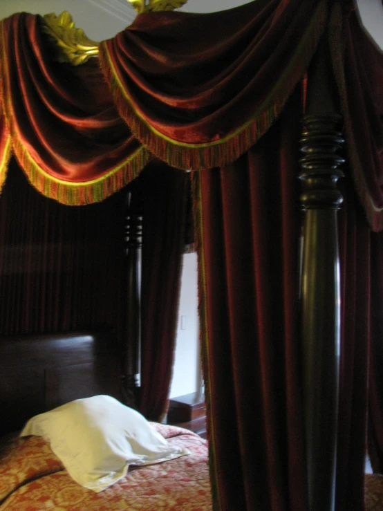 an ornate four poster canopy bed in a bedroom