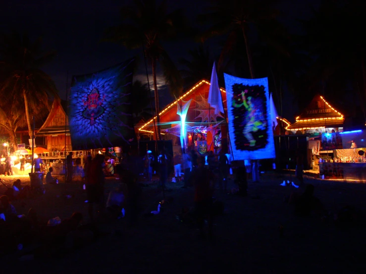 a picture taken at night of the outside of a tropical bar