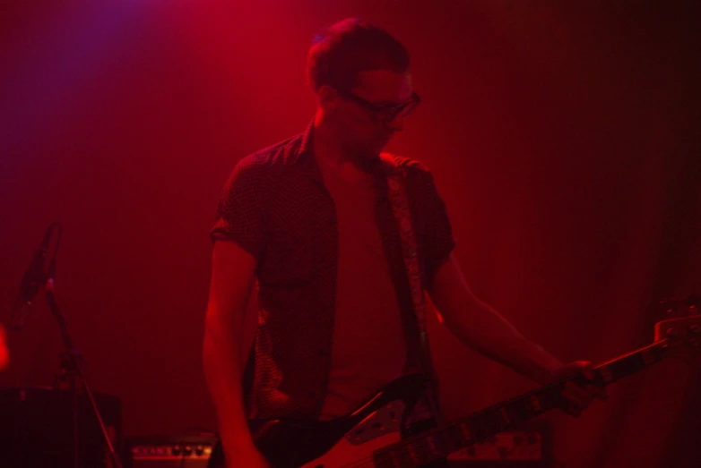 a man standing in front of a red background