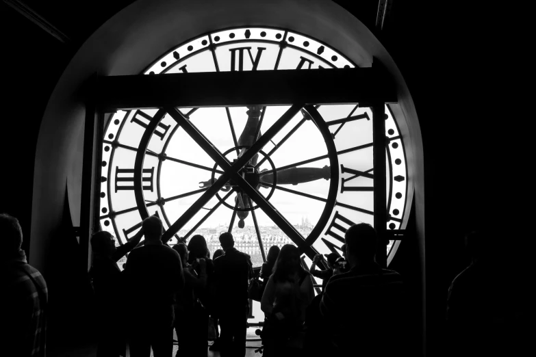 people in front of a clock face at the time