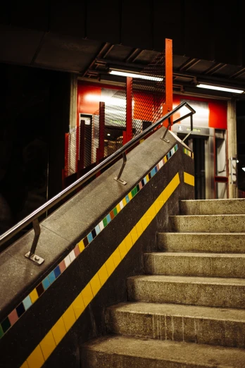 a stairway with colorful railing and railing bars