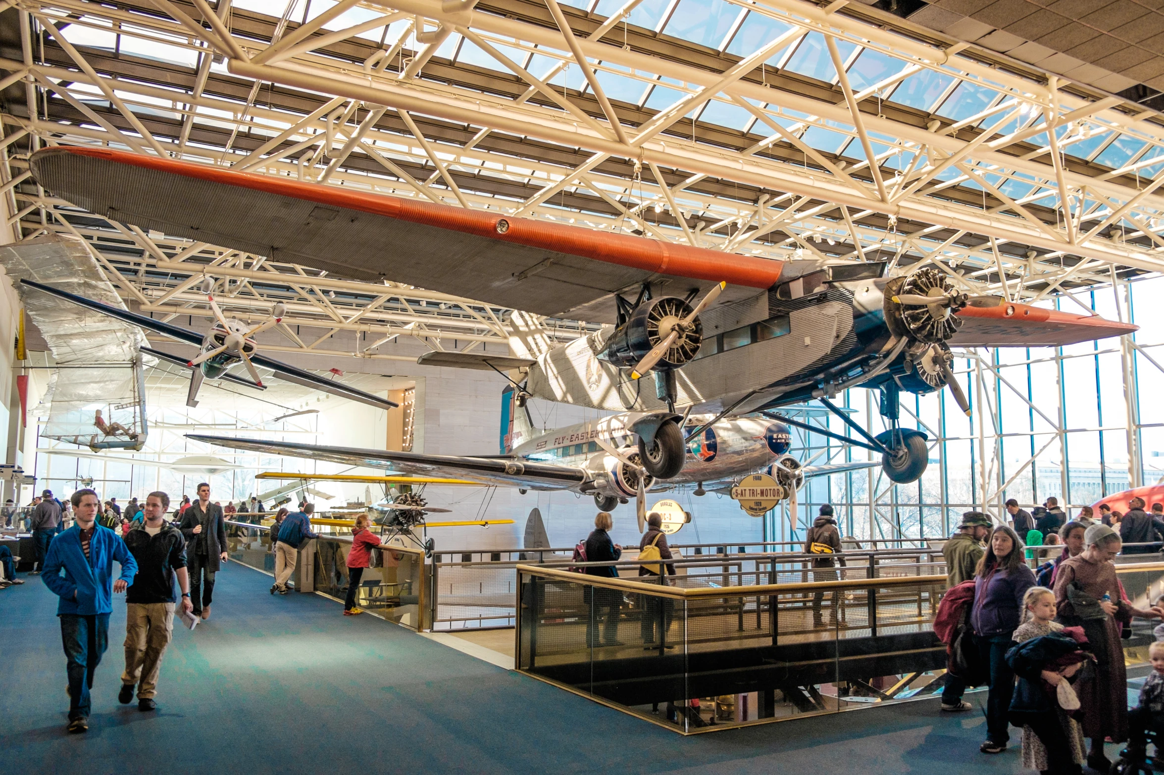 people are walking around and inside an airplane museum