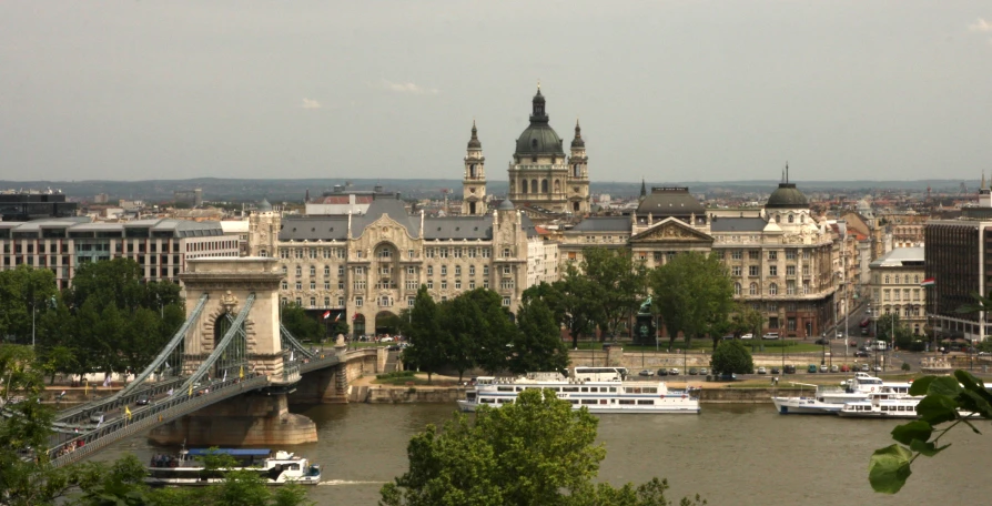 a bridge spanning over a river with lots of buildings and boats