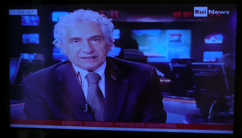 an old man in a suit and tie on a news show