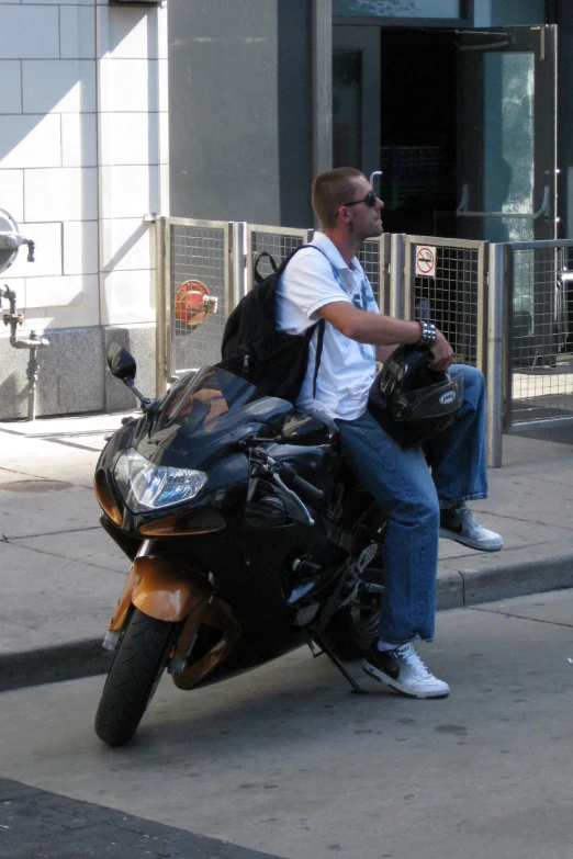 there is a man that is sitting on the motorcycle