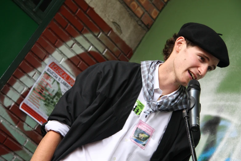 a boy that is standing in front of a microphone