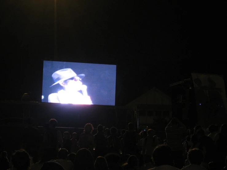 crowd looking at the screen with white light