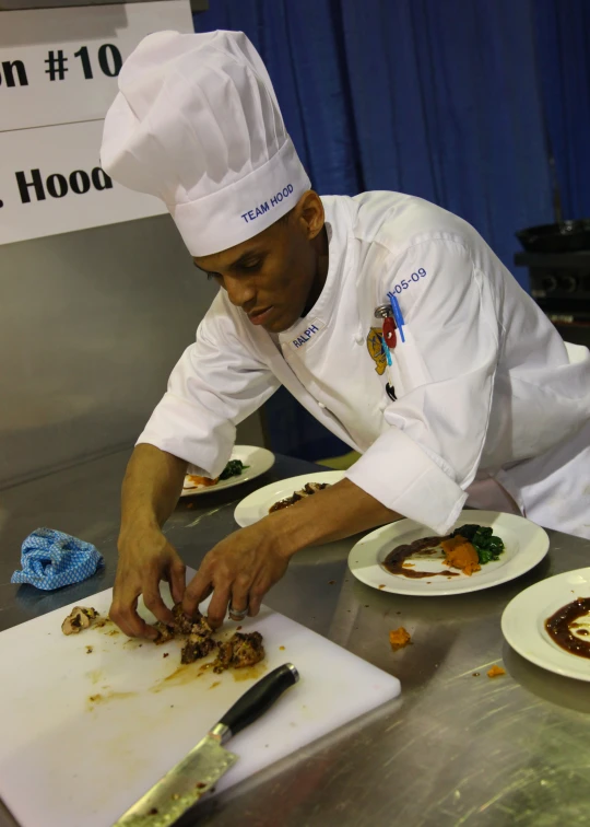 chef plating food onto plates at an event