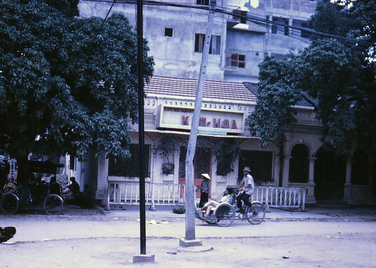 there are people that ride bikes outside the buildings