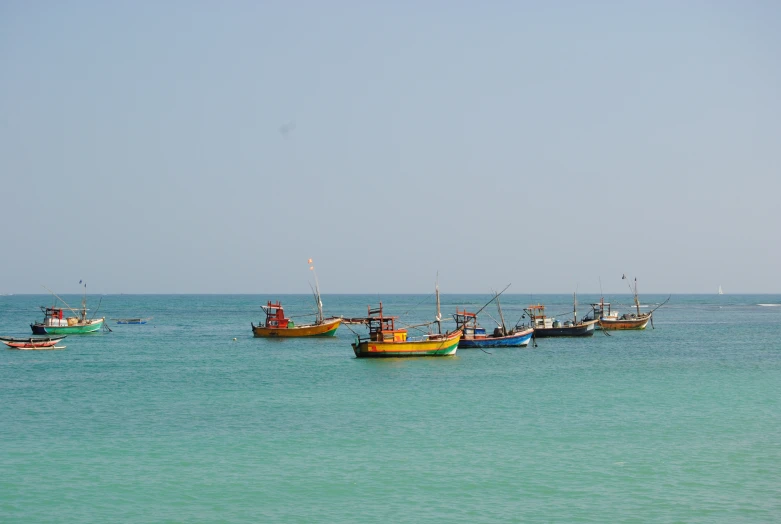 a group of small boats floating on top of a body of water