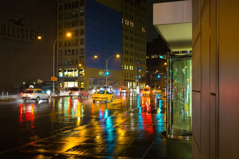 cars on a city street are parked at night