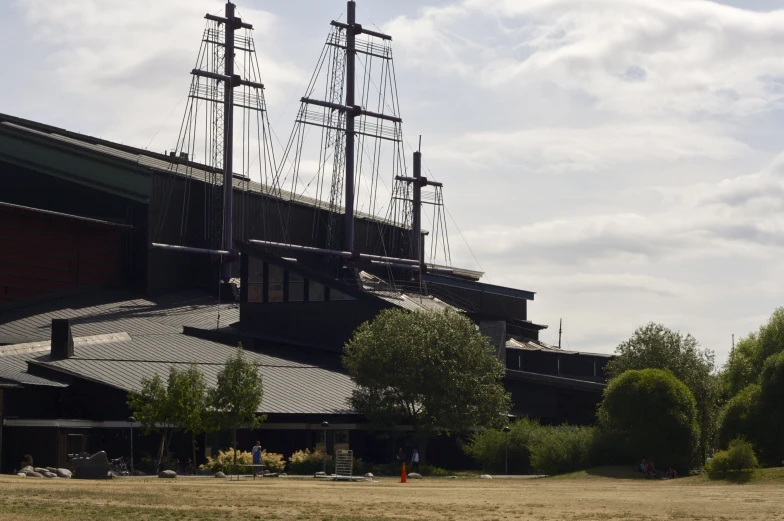 a boat sitting next to a building on top of a field