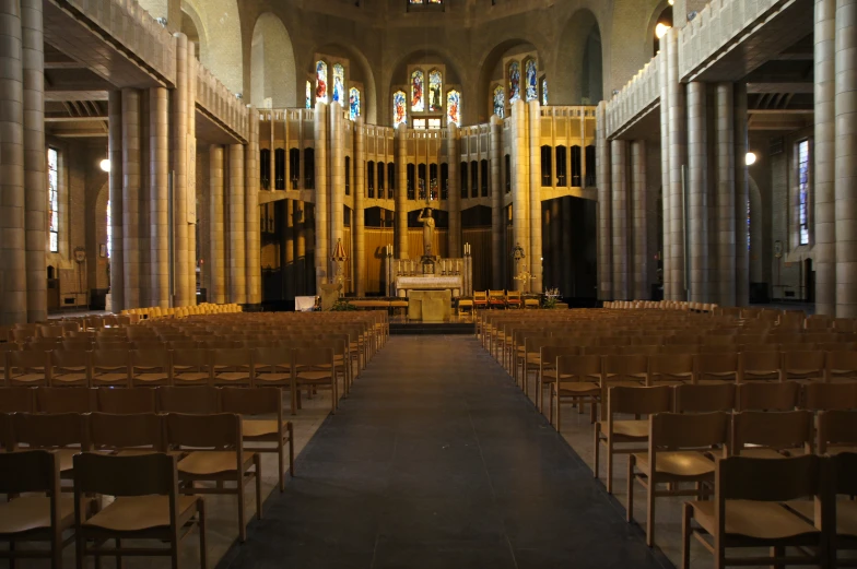 a big church with a bunch of wooden chairs lined up