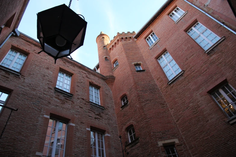 the bottom of two large brick buildings facing each other