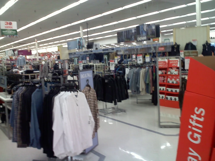 a room filled with lots of clothes hanging from hooks