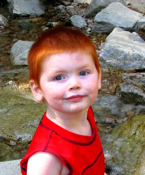 a very cute young child wearing a red shirt