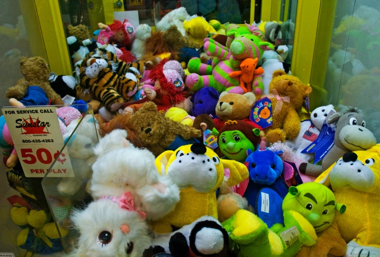 many stuffed animals are displayed with the price tag