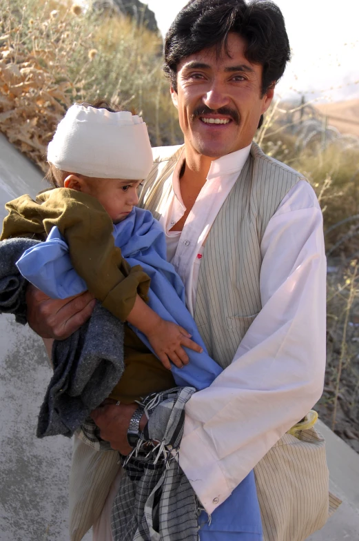 a man is holding a small child on his lap