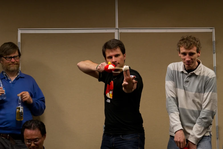 three men watching a man demonstrating soing