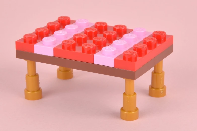 a red and white lego toy on a small table