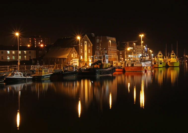 a group of boats in the water in front of a town