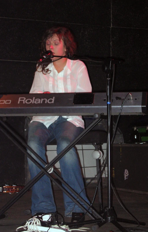 a woman on a keyboard with microphone next to her