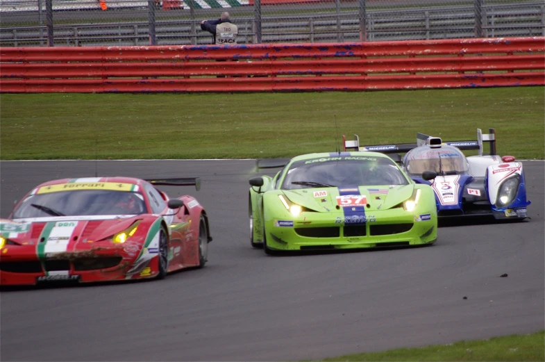 two cars on a race track in front of each other