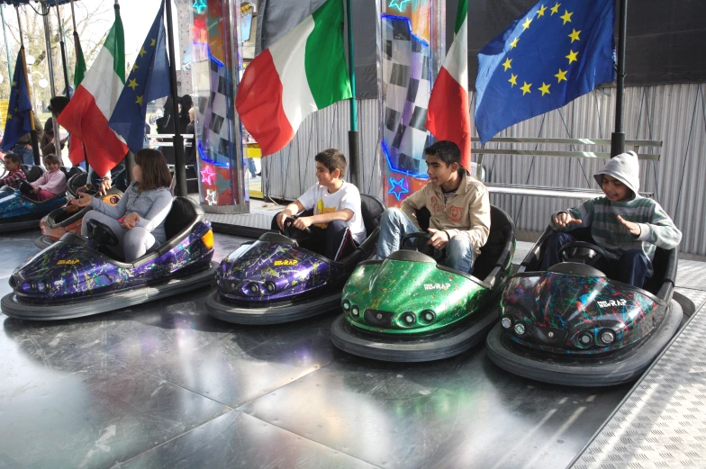 people sitting on bumper cars in an amut park