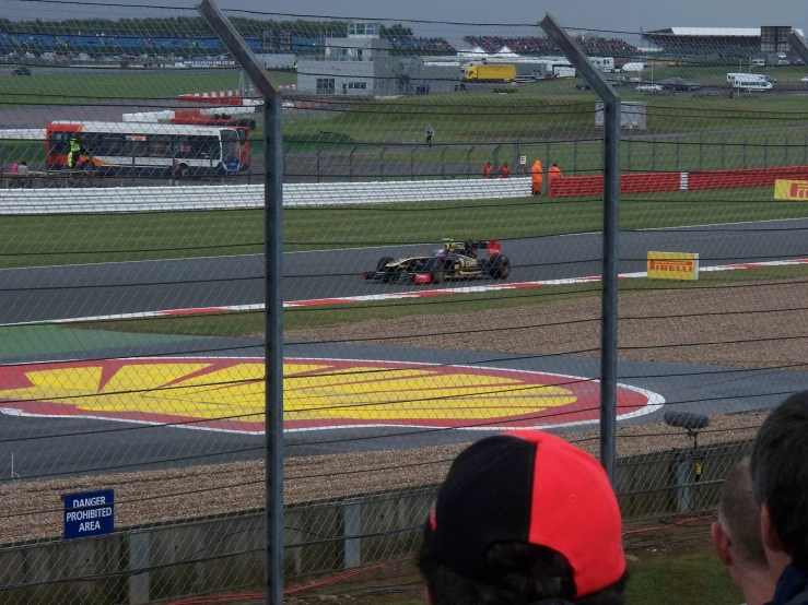 a man driving a racing car around a track