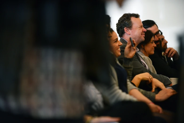 a group of people sitting next to each other