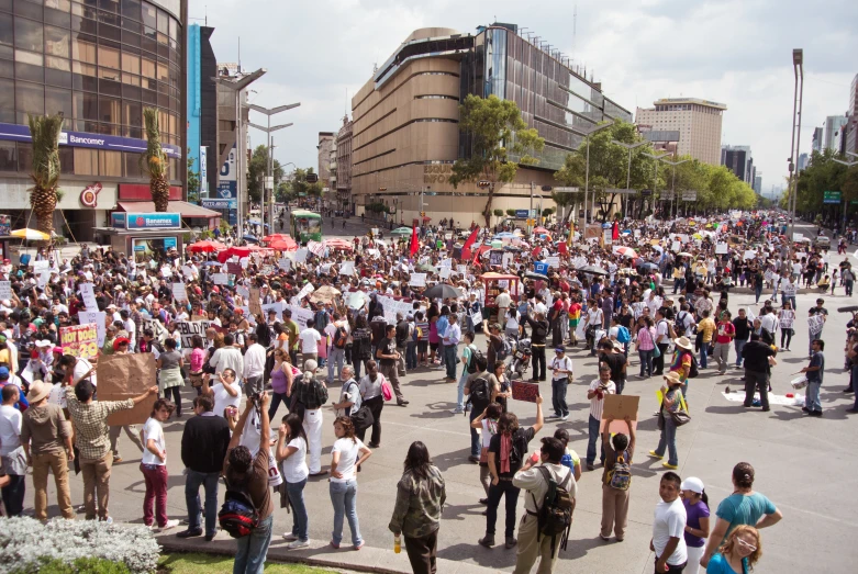 a large group of people gathering outside on the street