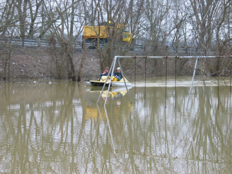 a person in a boat next to a metal fence