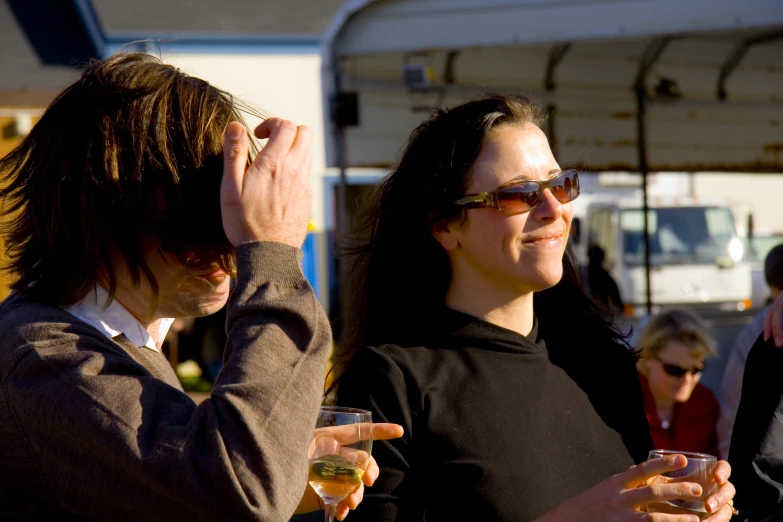 people standing around and holding glasses together