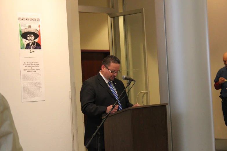 a man standing at a podium speaking