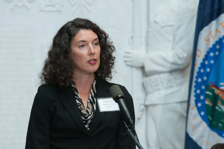 a woman standing in front of a microphone