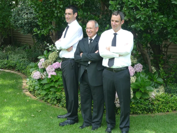 three men are standing next to each other