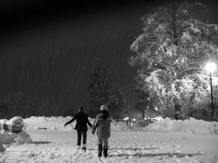 a man and a woman walking down a snowy street